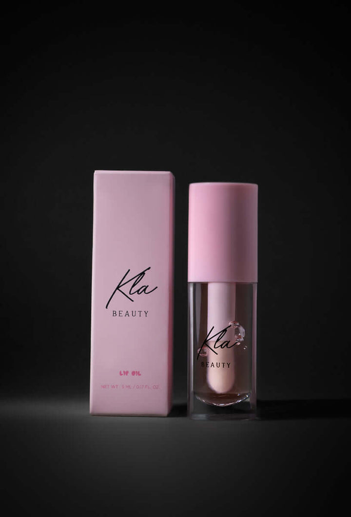 KLA Beauty Lip Oil Transparent Pink with packaging, offers vegan, cruelty-free glossy shine and hydration.