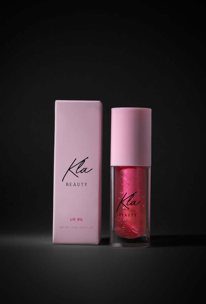 KLA Beauty Lip Oil in Glittery Pink with packaging, vegan and cruelty-free formula for glossy, hydrated, and plump lips.