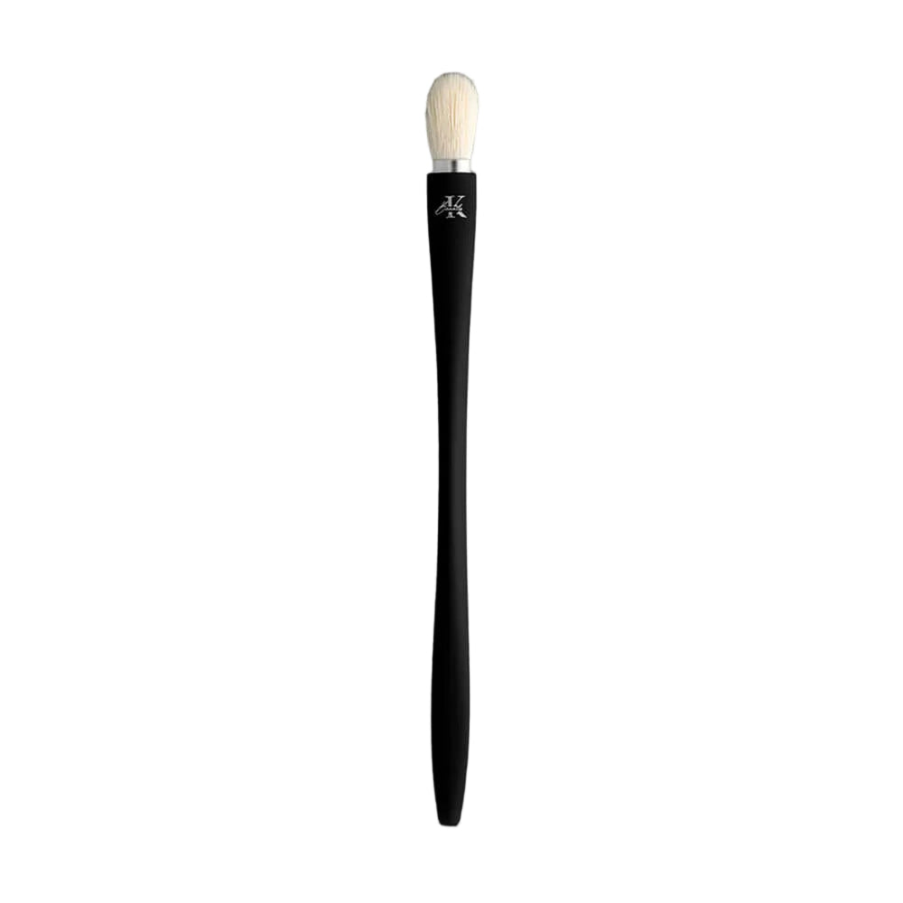KLA-beauty blending brush with sleek black handle and soft bristles, displayed on a gray background.
