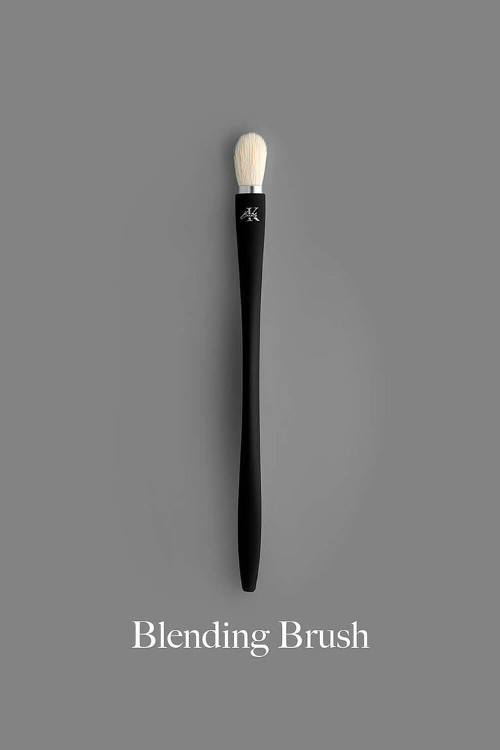 KLA-beauty blending brush with black handle and white bristles on gray background