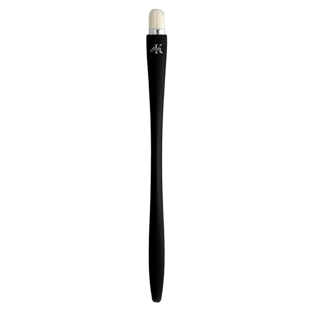 KLA-beauty concealer brush with sleek black handle and white bristles.