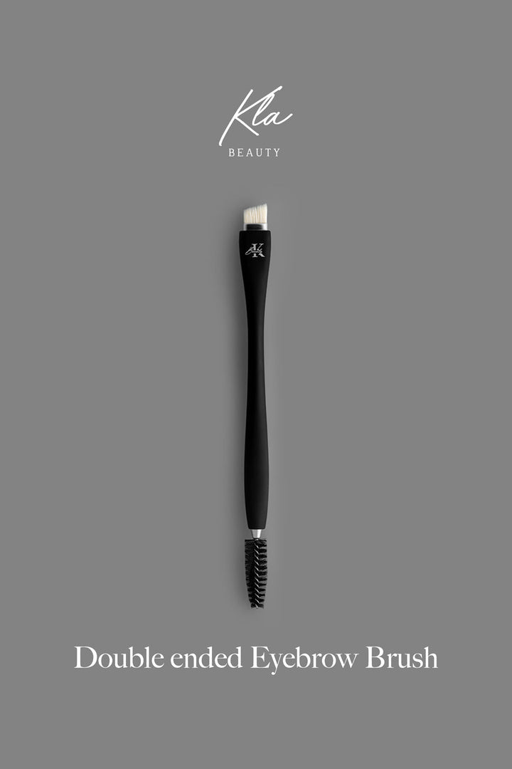 KLA-beauty double-ended eyebrow brush on a grey background for precise and flawless eyebrows.